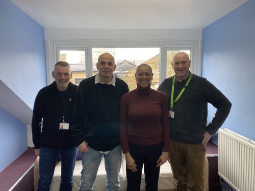 The Deputy Mayor with three people from Hope Housing stood smiling towards the camera.